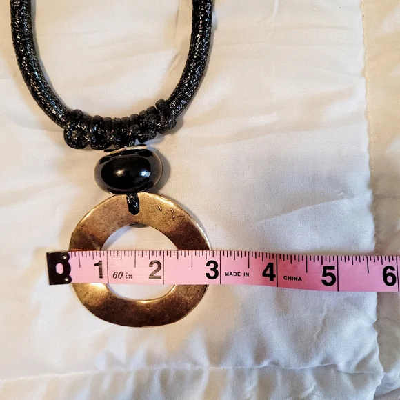 Black rope necklace with gold medal, black, and gray circle. - Picture 6 of 6